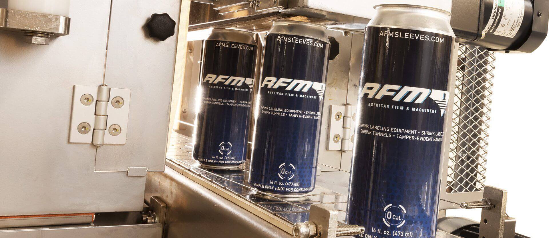 Cans exiting shrink tunnel.